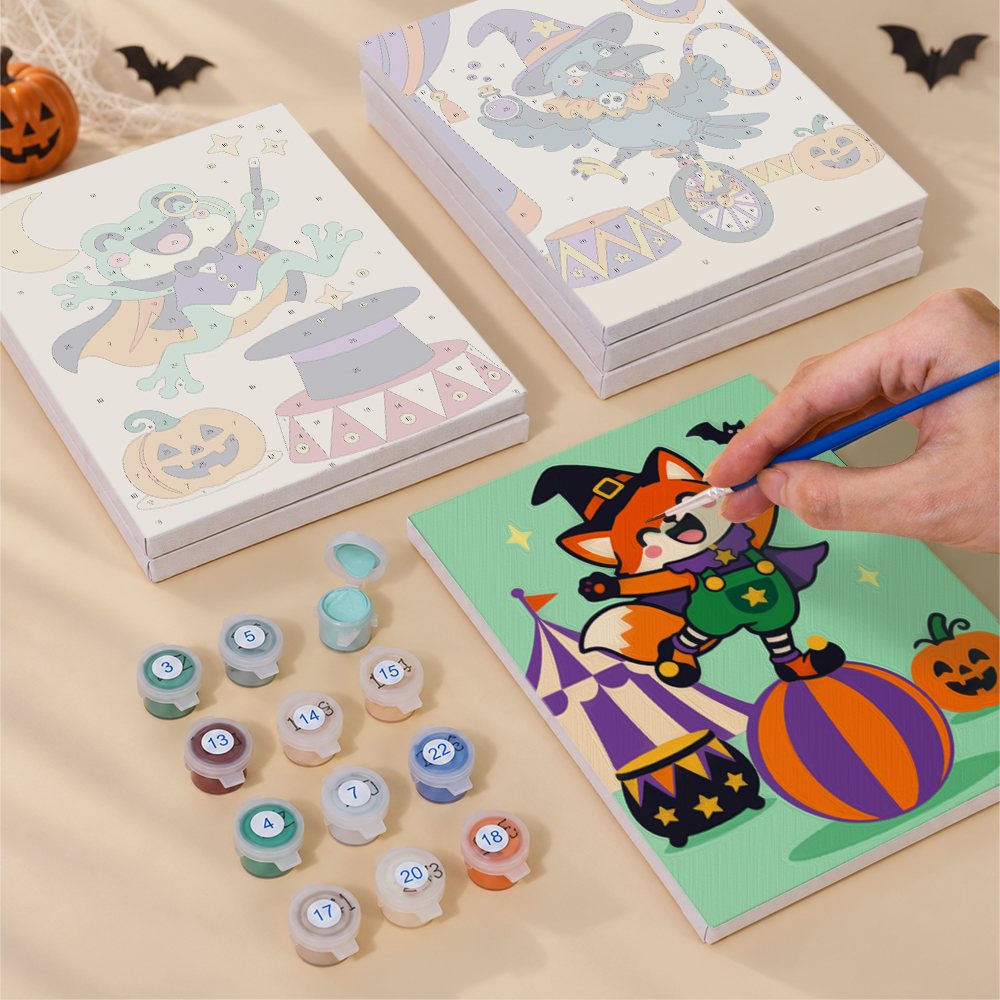 Painting one of the Halloween Circus Critters designs next to a stack of mini canvases