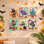 Six finished Halloween Circus Critters mini paintings hung on a wall above a table