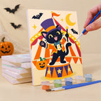 Painting a Halloween Circus Critters mini canvas propped up beside numbered acrylic paints
