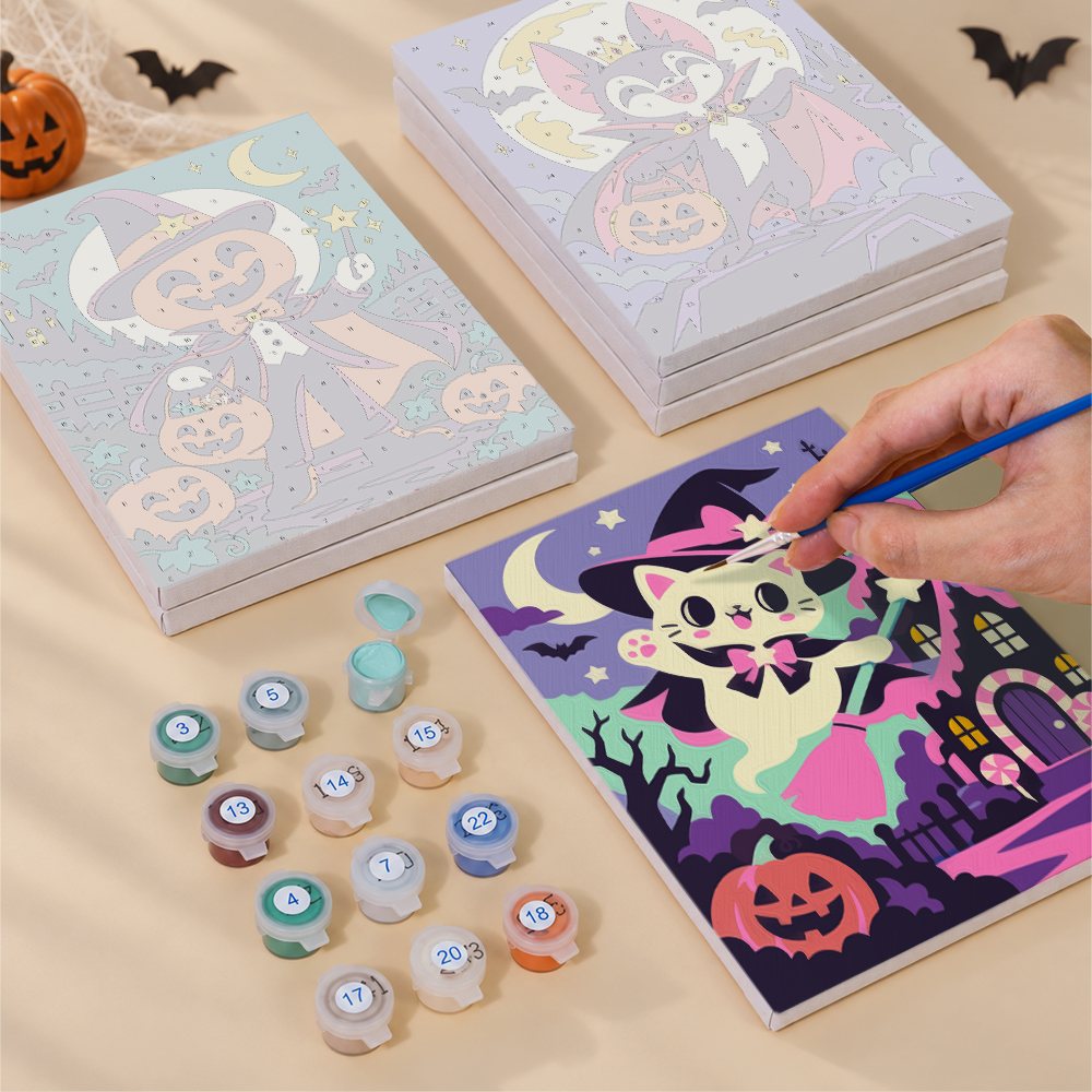 Painting one of the Halloween Costume Carnival designs next to a stack of mini canvases