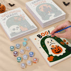 Painting one of the Halloween Greetings designs next to a stack of mini canvases