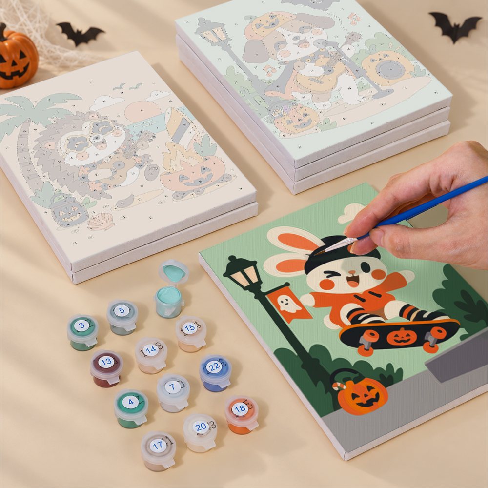 Painting one of the Halloween Jam Session designs next to a stack of mini canvases