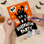 Hand holding a Halloween Party Signs mini canvas while painting the details