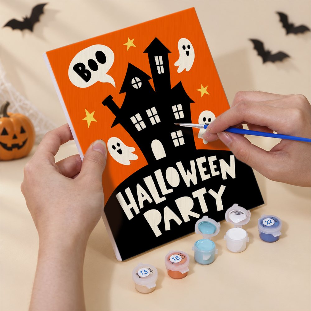 Hand holding a Halloween Party Signs mini canvas while painting the details