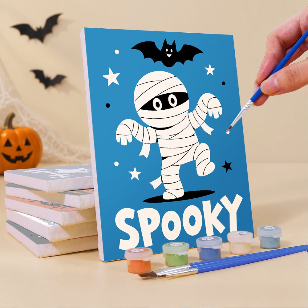 Painting a Halloween Party Signs mini canvas propped up beside numbered acrylic paints