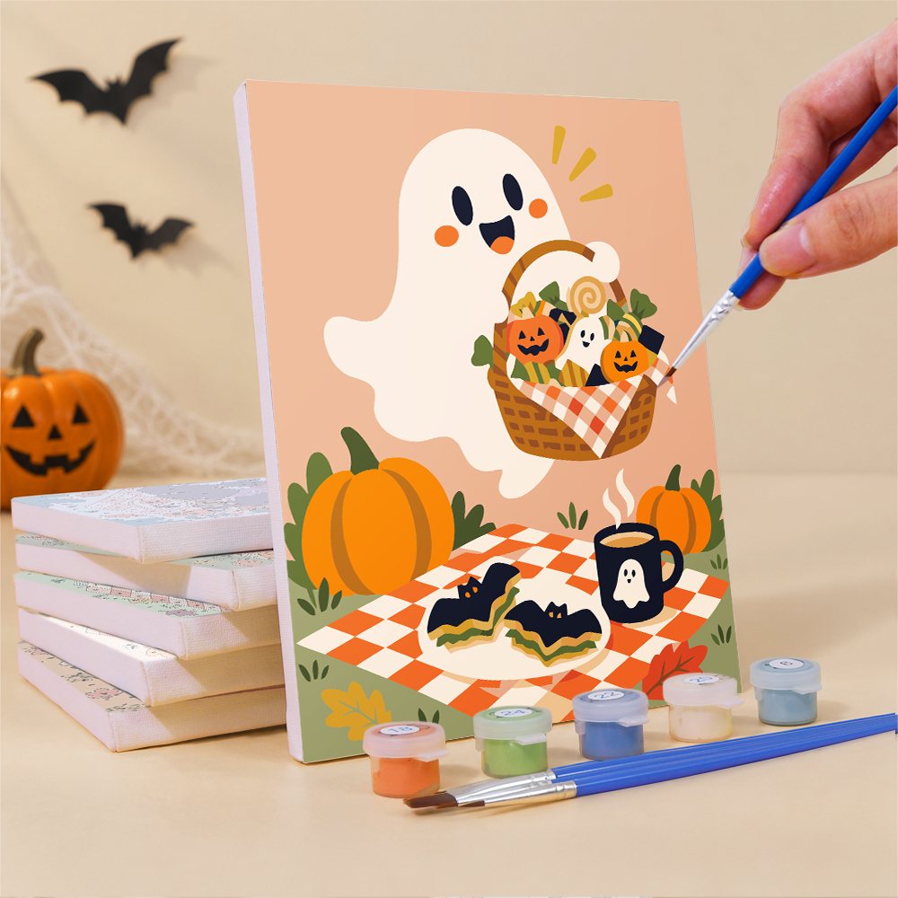 Painting a Halloween Picnic Party mini canvas propped up beside numbered acrylic paints