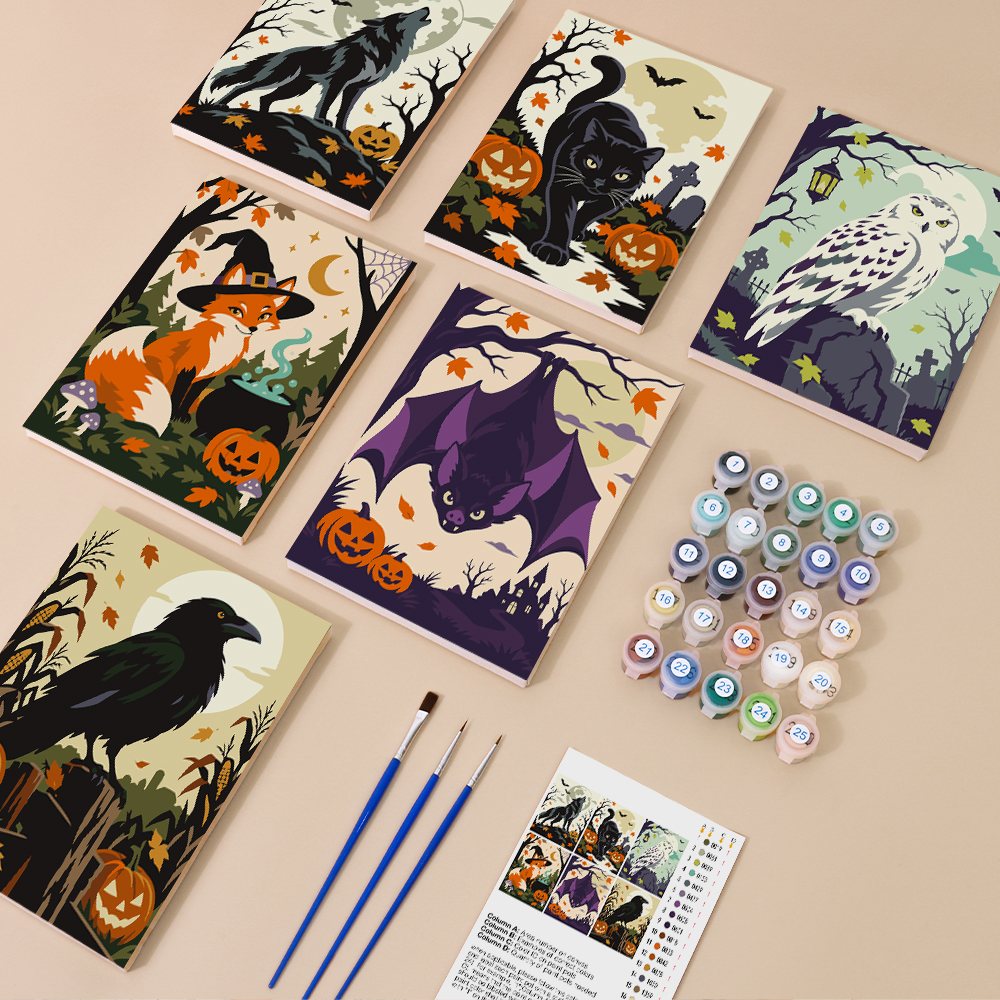 Painting one of the Halloween Woodland Creatures designs next to a stack of mini canvases