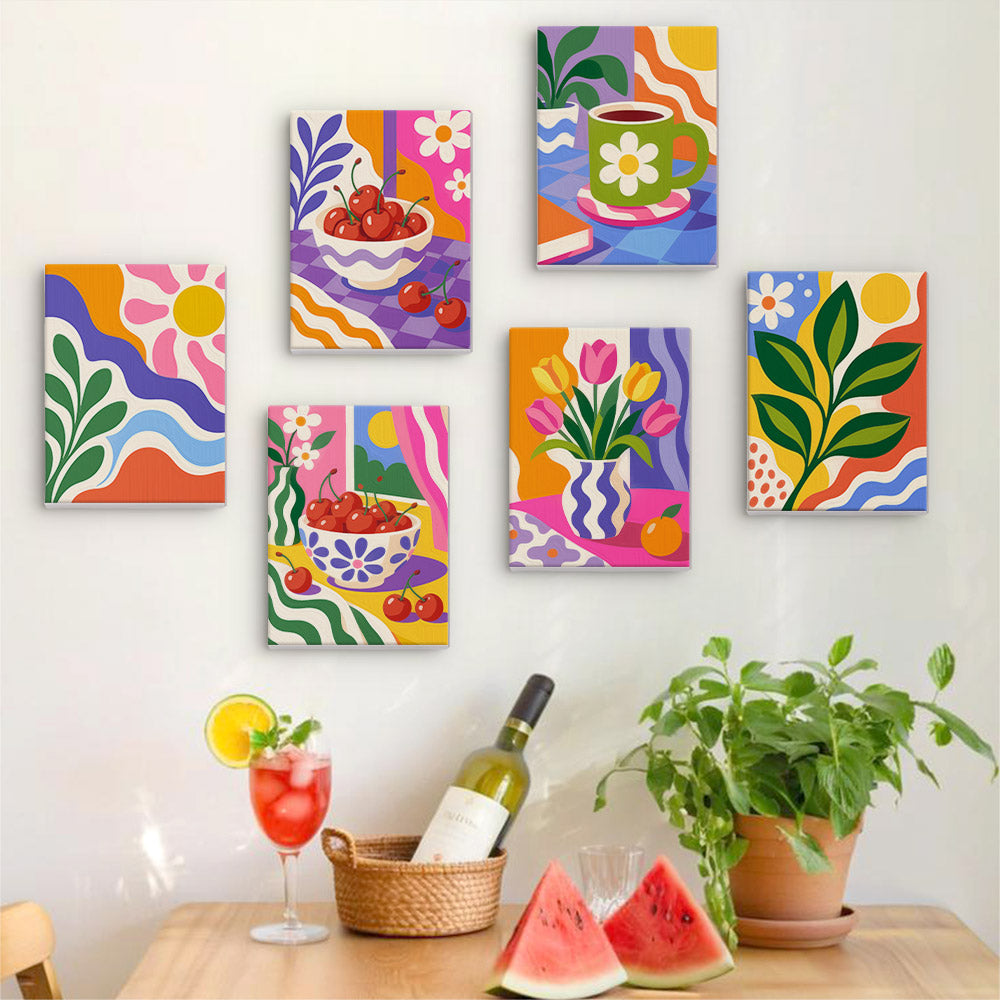Six finished Happy Hues mini paintings hung on a wall above a table