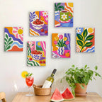 Six finished Happy Hues mini paintings hung on a wall above a table