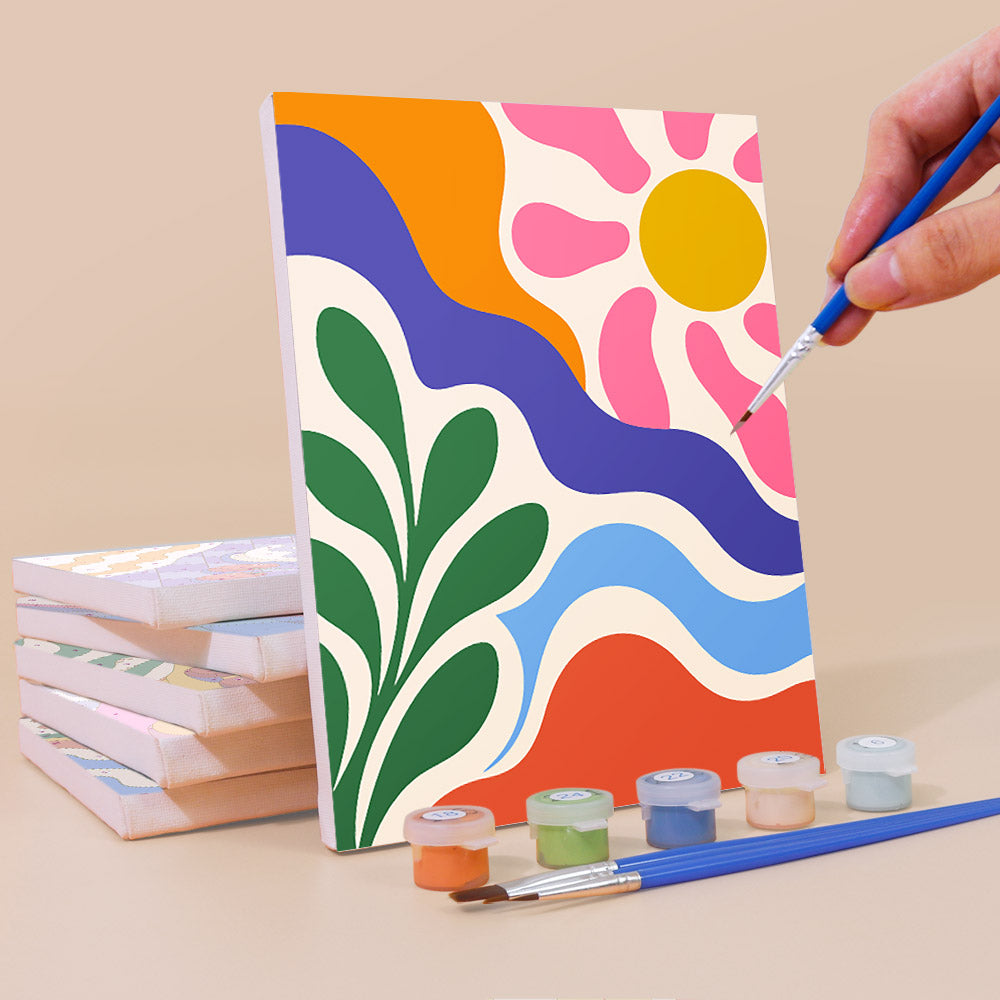 Painting a Happy Hues mini canvas propped up beside numbered acrylic paints