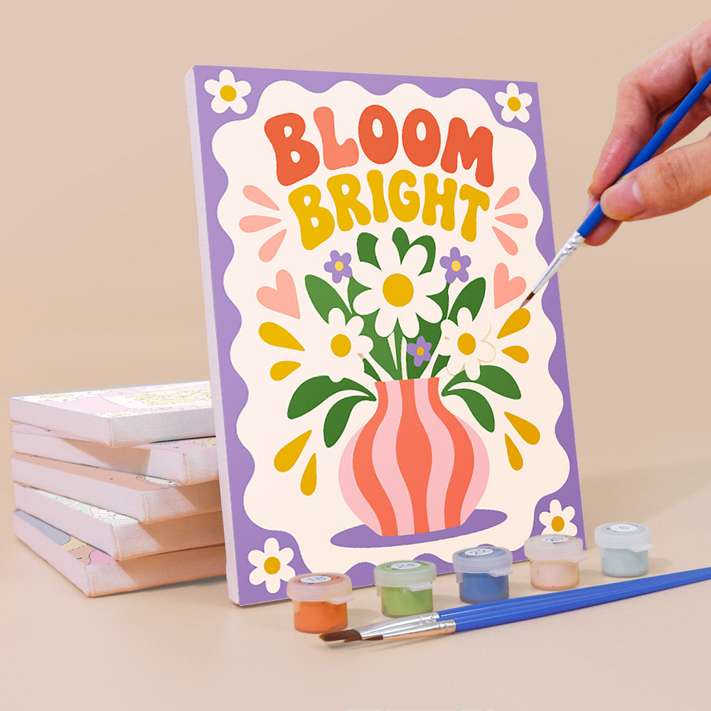 Painting a Happy Words mini canvas propped up beside numbered acrylic paints