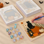 Painting one of the Harvest Hauntings designs next to a stack of mini canvases