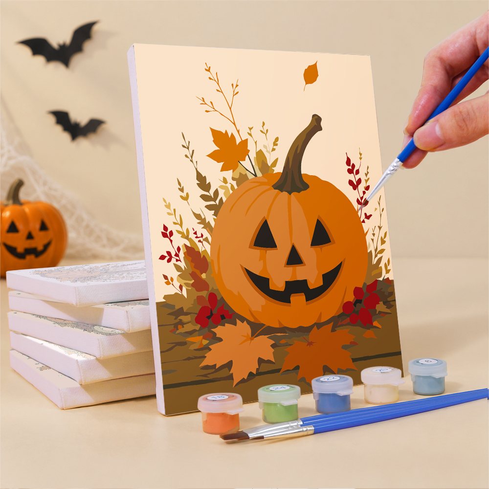 Painting a Harvest Hauntings mini canvas propped up beside numbered acrylic paints