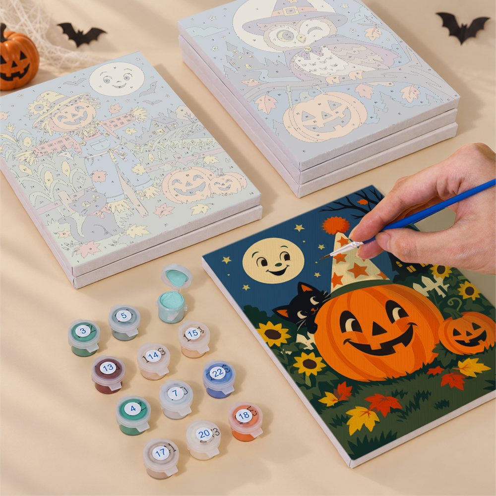 Painting one of the Harvest Moon Friends designs next to a stack of mini canvases