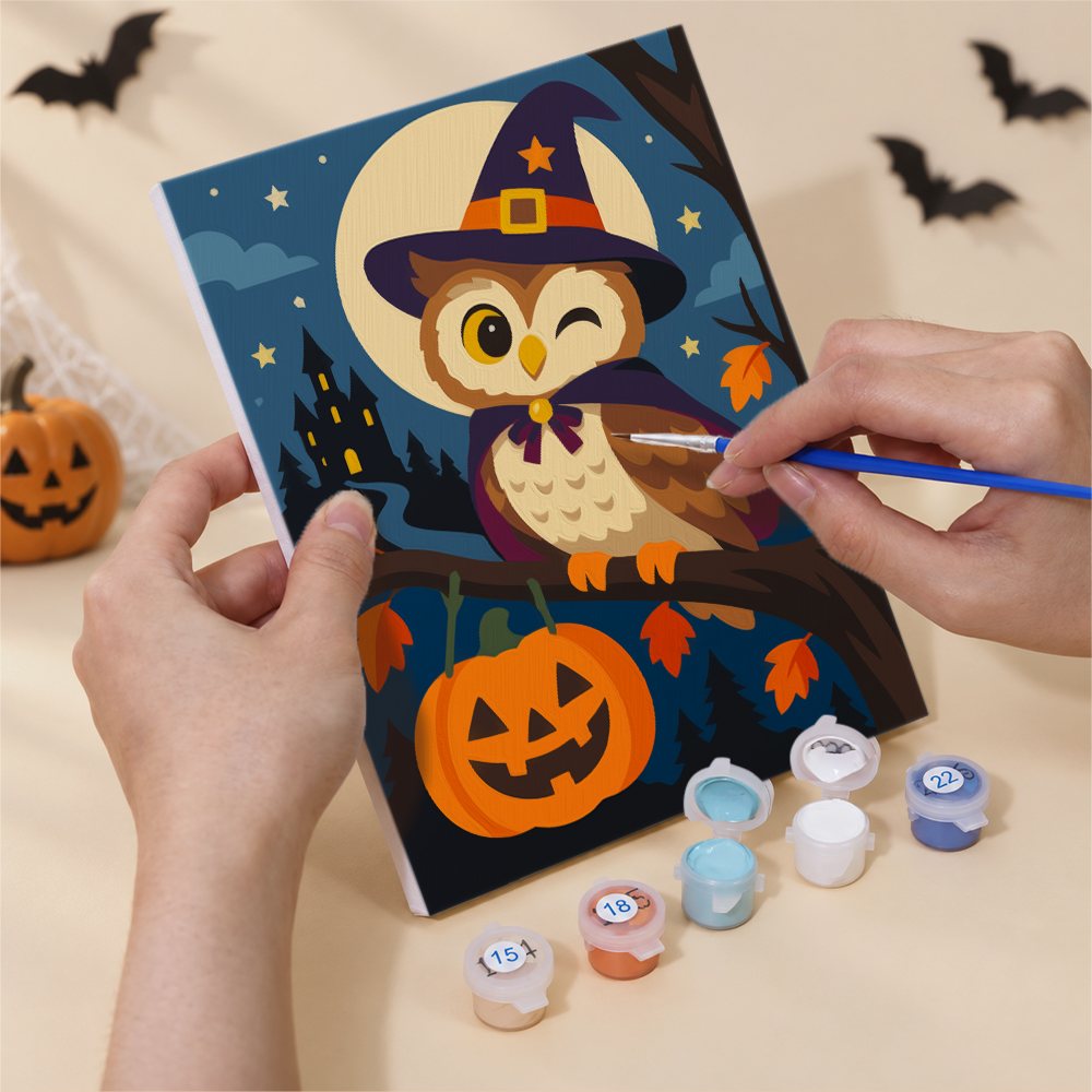 Hand holding a Harvest Moon Friends mini canvas while painting the details