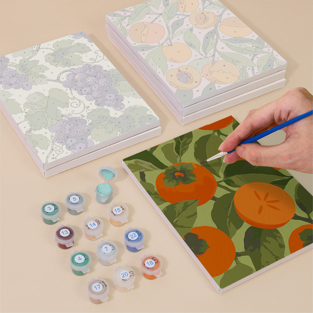 Painting one of the Harvest Patterns designs next to a stack of mini canvases