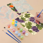 Filling in a Harvest Patterns mini canvas with numbered acrylic paints and a fine brush