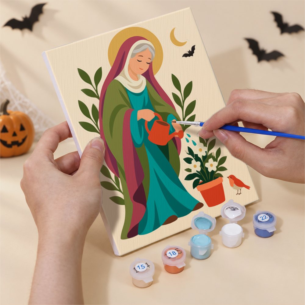Hand holding a Harvest Saints Folk Art mini canvas while painting the details