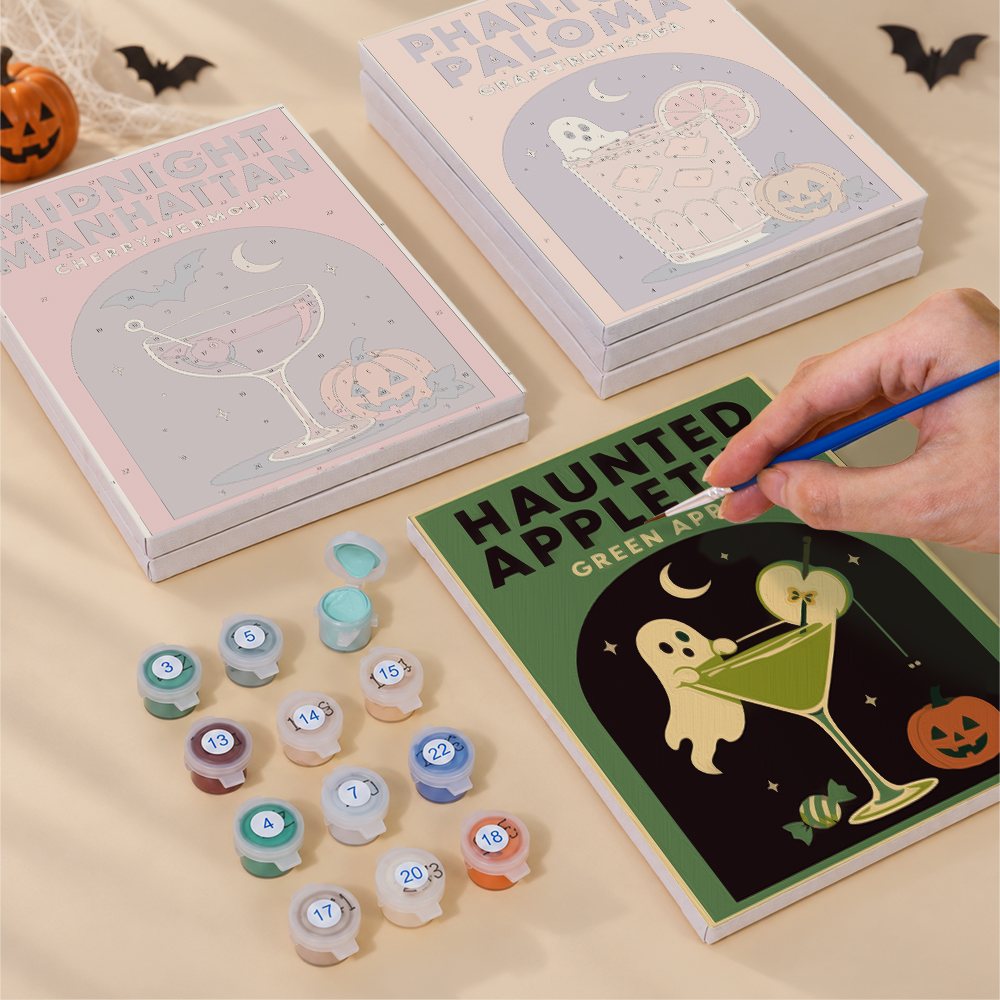 Painting one of the Haunted Happy Hour designs next to a stack of mini canvases