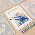 Numbered paint pots and brushes on a pre-stretched Haunted Happy Hour mini canvas