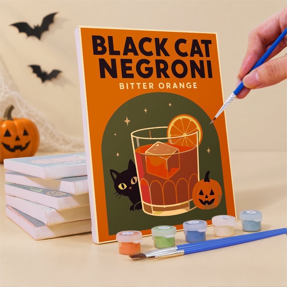 Painting a Haunted Happy Hour mini canvas propped up beside numbered acrylic paints
