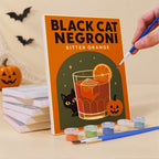 Painting a Haunted Happy Hour mini canvas propped up beside numbered acrylic paints
