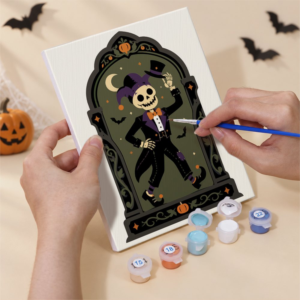 Hand holding a Haunted Portraits mini canvas while painting the details