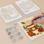 Painting one of the Hello Autumn designs next to a stack of mini canvases