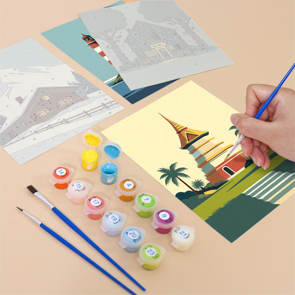 Filling in a Homes Around the World mini canvas with numbered acrylic paints and a fine brush