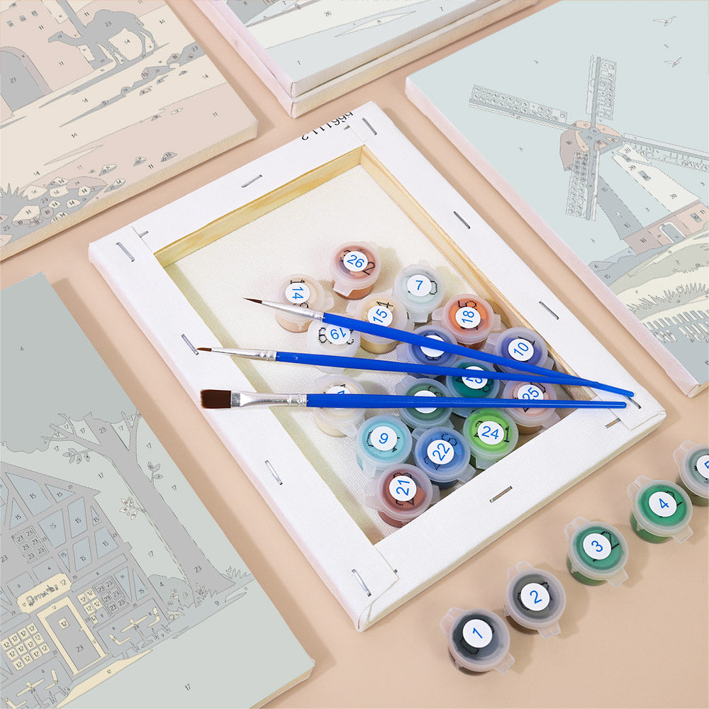 Numbered paint pots and brushes on a pre-stretched Homes Around the World mini canvas