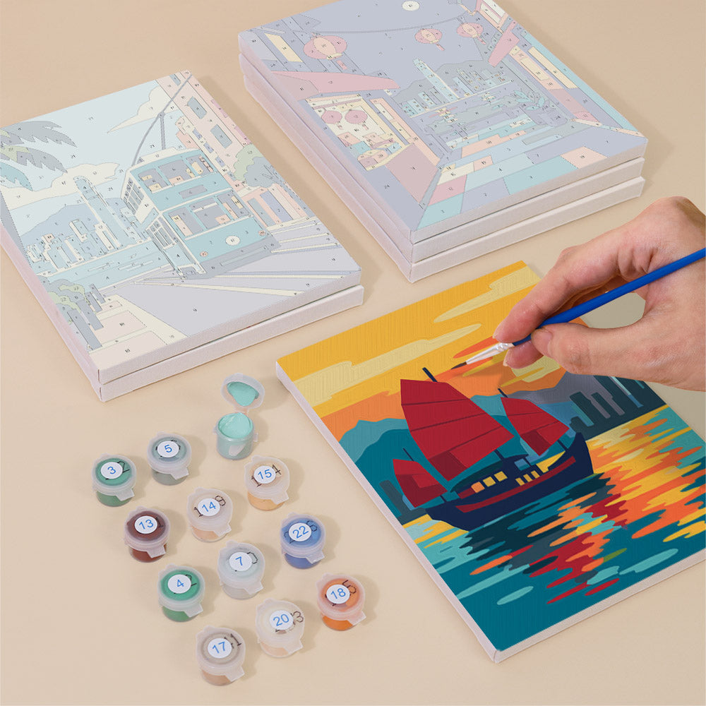Painting one of the Hong Kong Harbor designs next to a stack of mini canvases