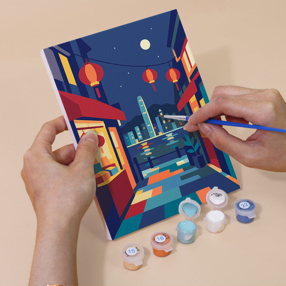 Hand holding a Hong Kong Harbor mini canvas while painting the details