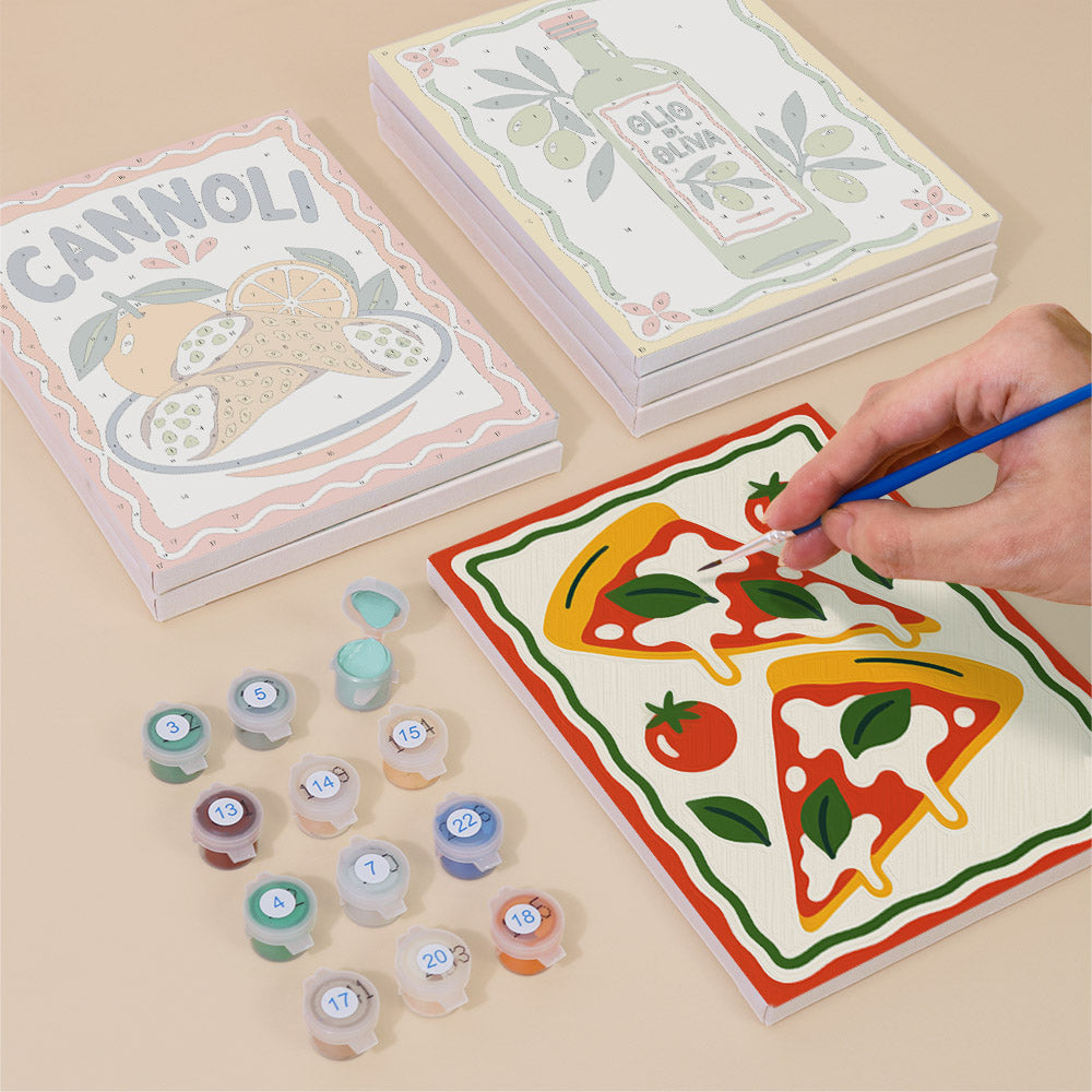 Painting one of the Italian Feast designs next to a stack of mini canvases