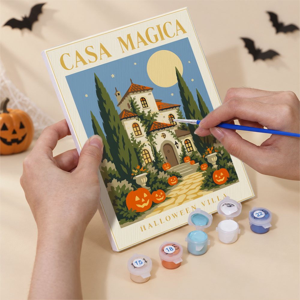 Hand holding an Italian Halloween Botanicals mini canvas while painting the details