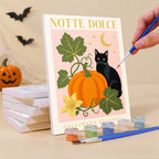 Painting an Italian Halloween Botanicals mini canvas propped up beside numbered acrylic paints