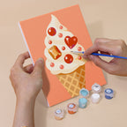 Hand holding a Jeweled Cones mini canvas while painting the details