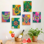 Six finished Jungle Bugs mini paintings hung on a wall above a table