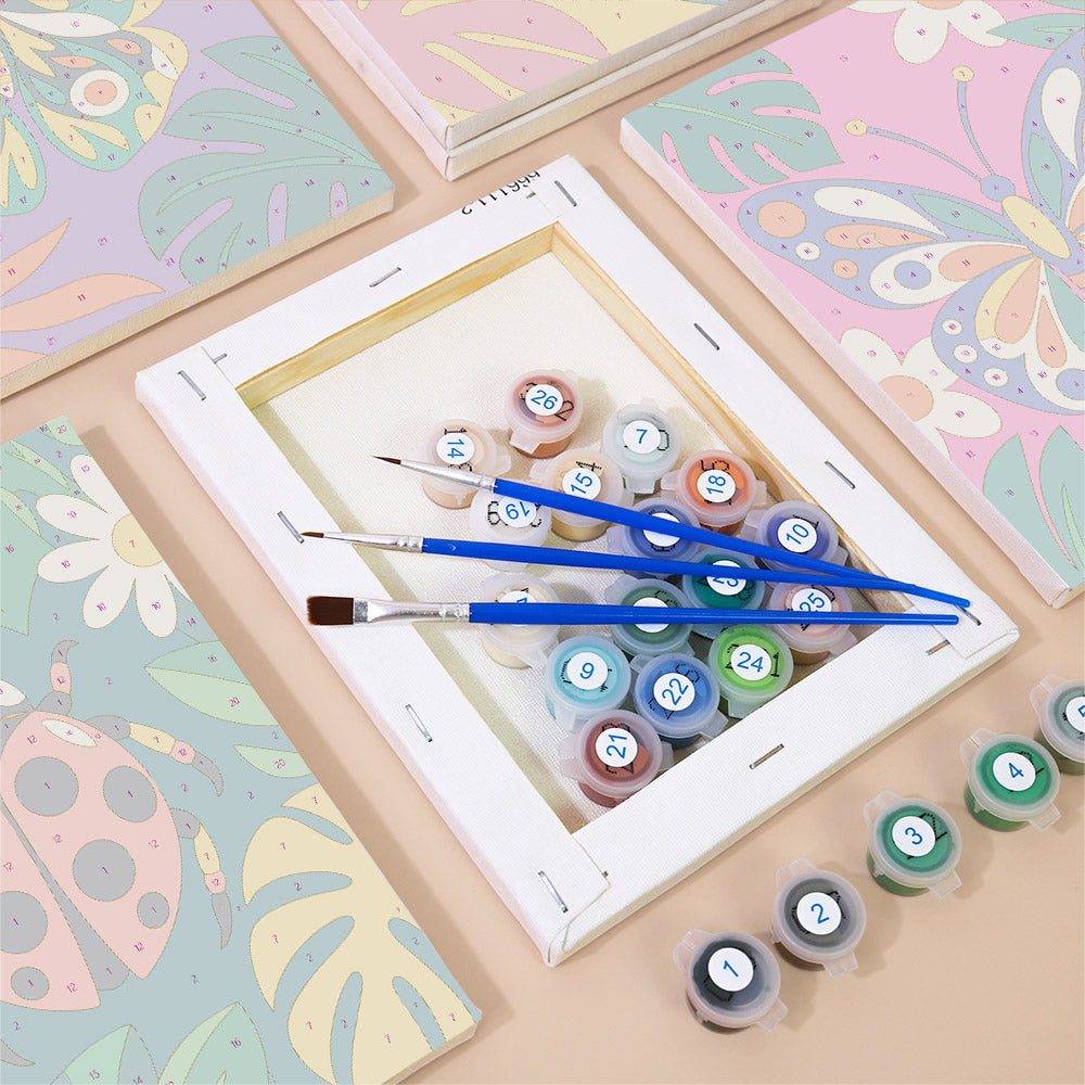 Numbered paint pots and brushes on a pre-stretched Jungle Bugs mini canvas