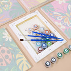 Numbered paint pots and brushes on a pre-stretched Jungle Bugs mini canvas