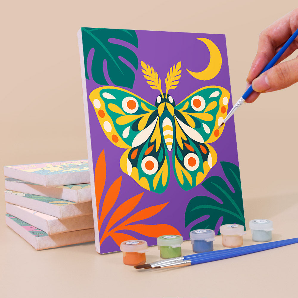 Painting a Jungle Bugs mini canvas propped up beside numbered acrylic paints