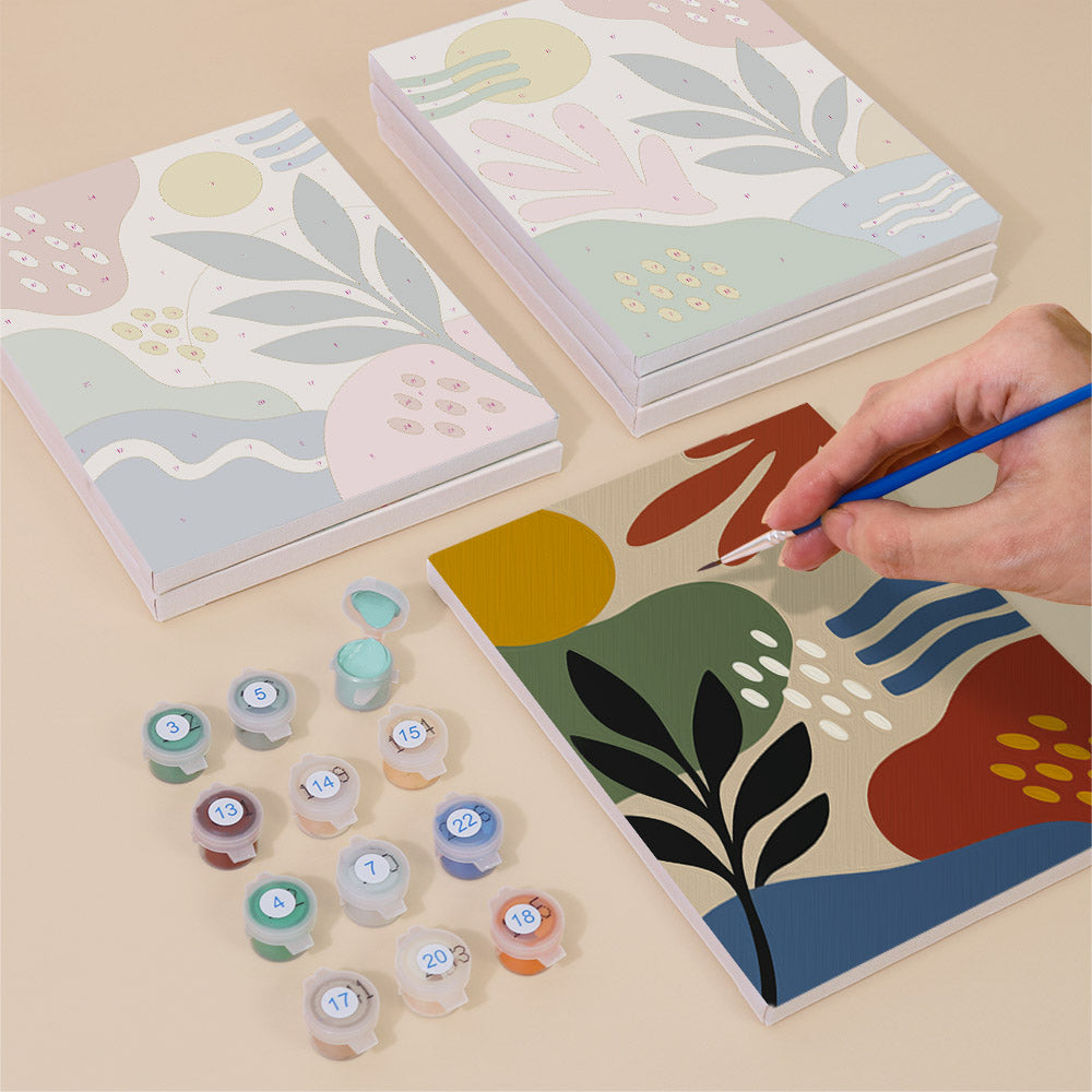Painting one of the Jungle Collage designs next to a stack of mini canvases