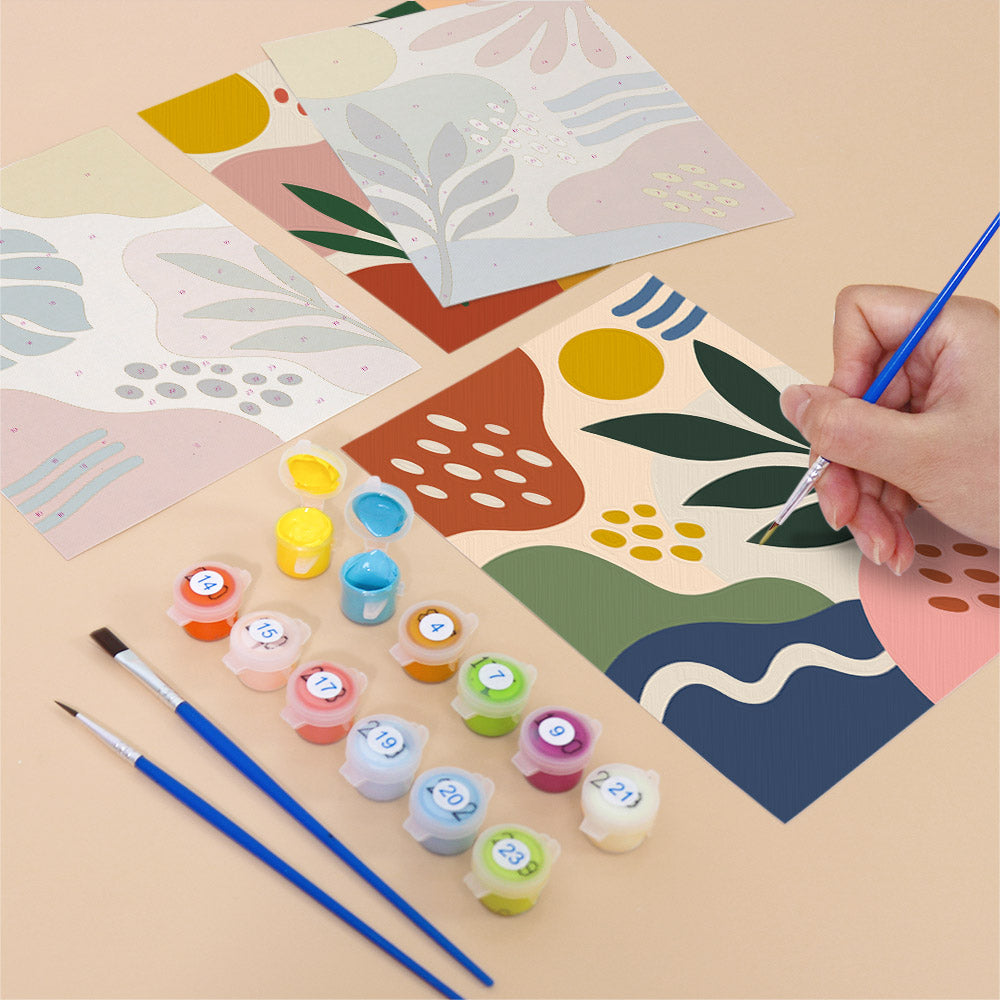 Filling in a Jungle Collage mini canvas with numbered acrylic paints and a fine brush