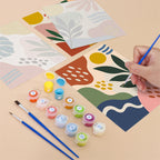 Filling in a Jungle Collage mini canvas with numbered acrylic paints and a fine brush