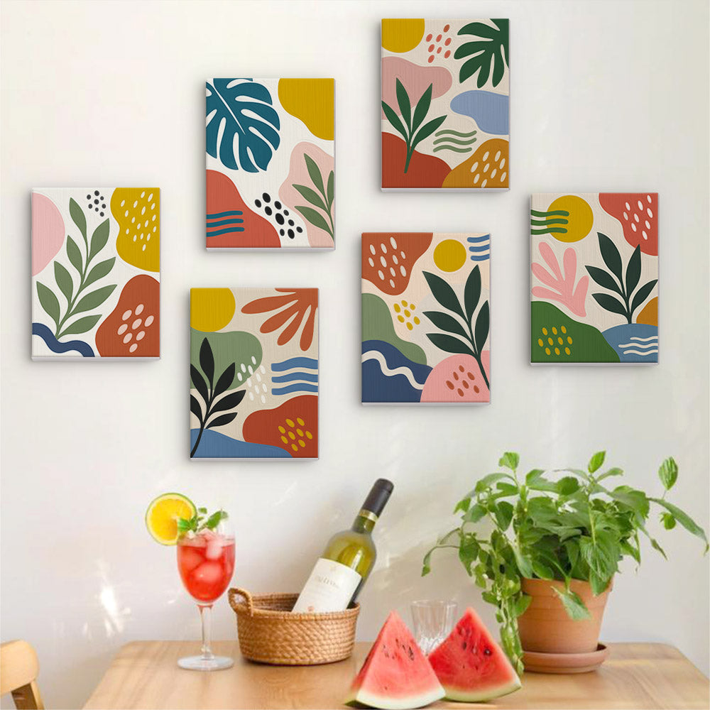 Six finished Jungle Collage mini paintings hung on a wall above a table