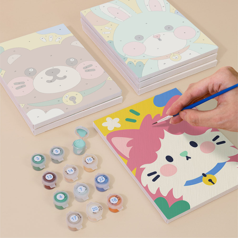 Painting one of the Kawaii Pals designs next to a stack of mini canvases