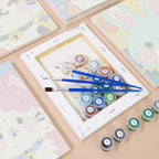 Numbered paint pots and brushes on a pre-stretched Kawaii Pals mini canvas