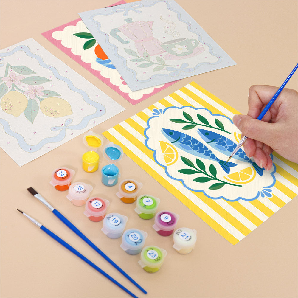 Filling in a Kitchen Charm mini canvas with numbered acrylic paints and a fine brush