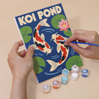 Hand holding a Kyoto Posters mini canvas while painting the details