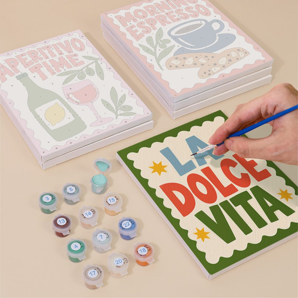 Painting one of the La Dolce Vita designs next to a stack of mini canvases