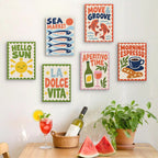 Six finished La Dolce Vita mini paintings hung on a wall above a table